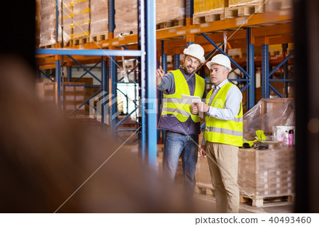 Nice positive man pointing at the storage shelves 40493460