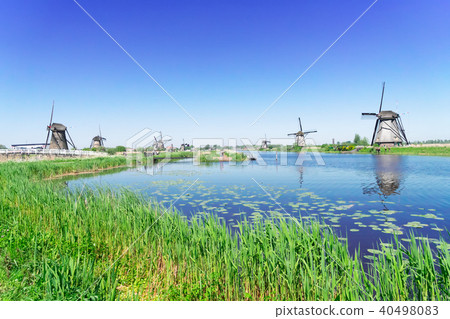 dutch windmill over river waters dutch windmill over river waters 40498083