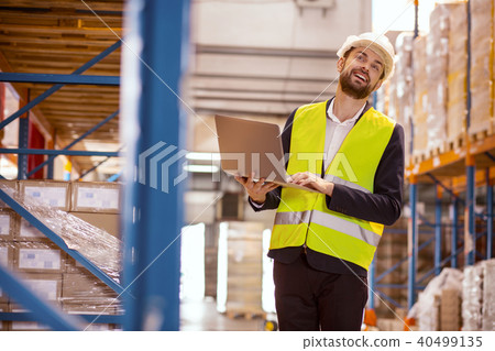 Smart positive man observing the working process 40499135