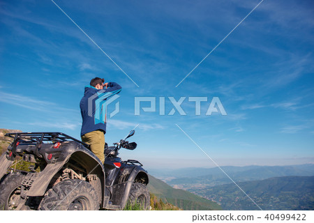 Man on the ATV Quad Bike on the mountains road. 40499422