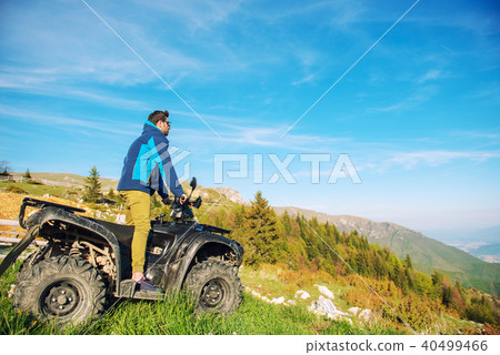 Man on the ATV Quad Bike on the mountains road. 40499466