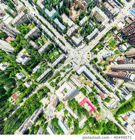 Aerial city view with crossroads and roads, houses, buildings, parks and parking lots. Sunny summer 40499871