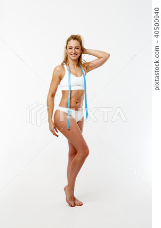 Picture of slender girl with centimeter ribbon in studio 40500940