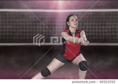 Female professional volleyball player on volleyball court Female professional volleyball player on volleyball court 40501050