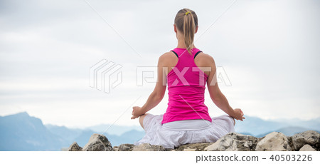 Woman meditating at the lake Woman meditating at the lake 40503226
