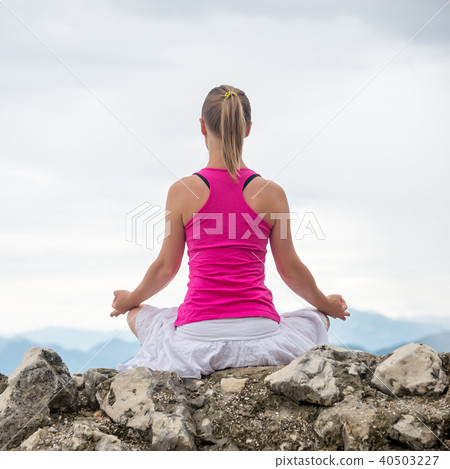 Woman meditating at the lake Woman meditating at the lake 40503227