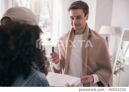 Happy handsome man holding a credit card Happy handsome man holding a credit card 40503230