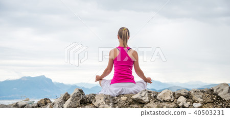 Woman meditating at the lake Woman meditating at the lake 40503231