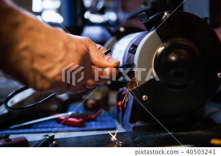 Photo of man sharpening tool Photo of man sharpening tool 40503241