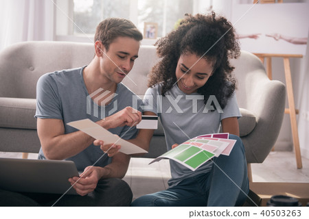 Positive joyful woman choosing colors Positive joyful woman choosing colors 40503263