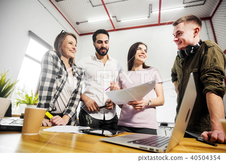Office Workers Discuss Diagrams Office Workers Discuss Diagrams 40504354