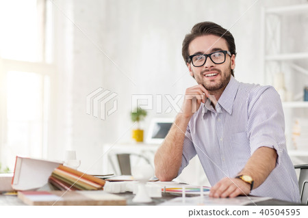 Cheerful businessman sitting at the table Cheerful businessman sitting at the table 40504595