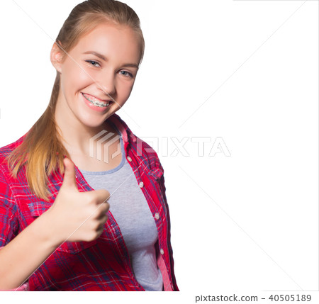 Portrait of teen girl showing dental braces. 40505189