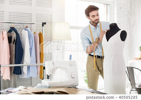Professional dressmaker working on a new dress Professional dressmaker working on a new dress 40505285