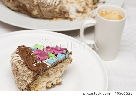 Cake with cream, nuts and meringue with cup of coffee 40505522