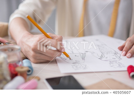 Tender female couturier drawing sketch 40505607