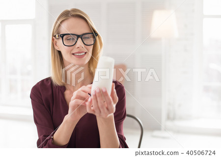 Musing female designer examining sample 40506724