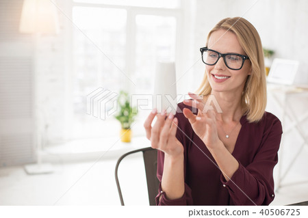 Cheerful female designer evaluating sample Cheerful female designer evaluating sample 40506725