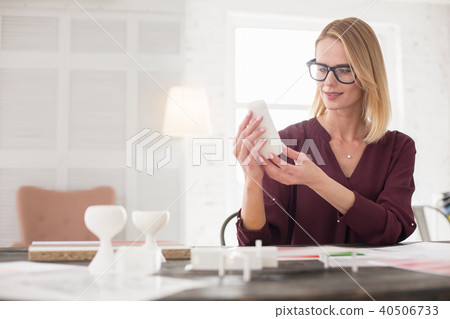 Thoughtful female designer scrutinizing sample Thoughtful female designer scrutinizing sample 40506733