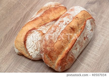 two tasty baked bread on a light wooden background 40507034