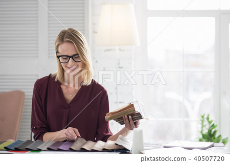 Merry female designer opting for upholstery 40507720