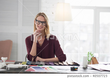 Optimistic female designer making decision about upholstery 40507723