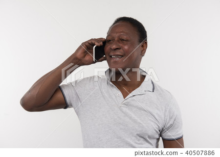 Joyful nice man talking on the phone Joyful nice man talking on the phone 40507886