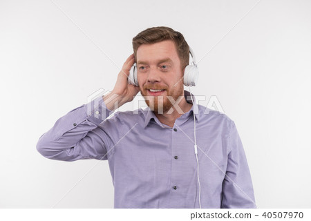 Delighted positive man listening to music Delighted positive man listening to music 40507970