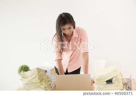 Asian women using laptops with large documents 40508371