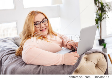 Cheerful woman working on her laptop 40508563