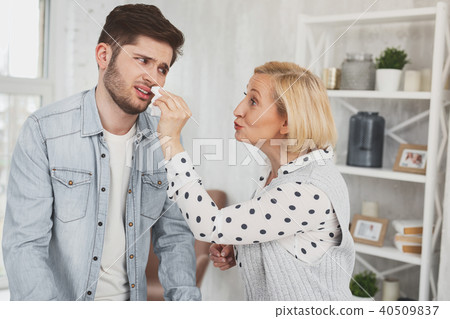 Nice aged woman wiping her sons nose Nice aged woman wiping her sons nose 40509837