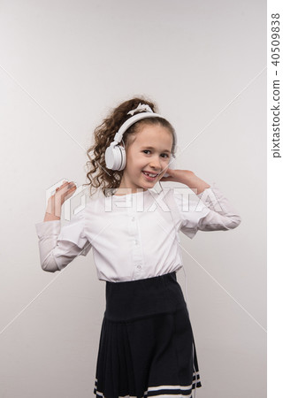 Delighted cute girl listening to music Delighted cute girl listening to music 40509838