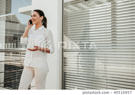 Businesswoman enjoying pleasant dialog by cellphone 40510957