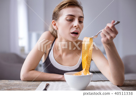 Nice young woman sitting at the table Nice young woman sitting at the table 40511338
