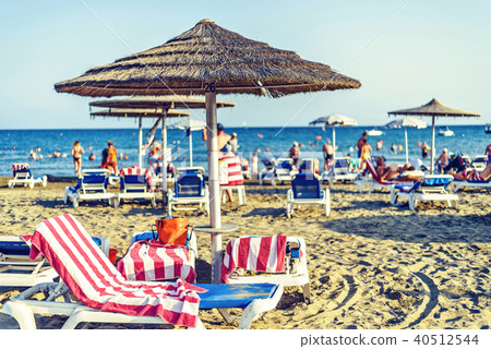 Daylight view to beachline with tourists relaxing Daylight view to beachline with tourists relaxing 40512544