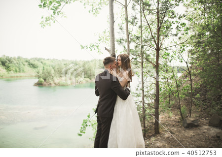 Wedding couple in love kissing and hugging near rocks on beautiful landscape Wedding couple in love kissing and hugging near rocks on beautiful landscape 40512753