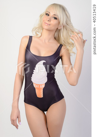 beautiful slim girl in a black bathing suit poses 40513419