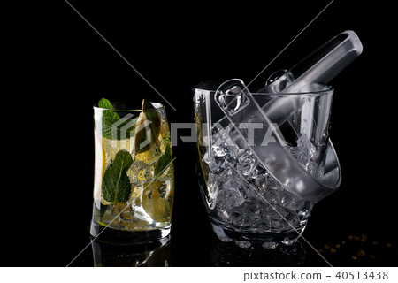Glass ice bucket and mohito cocktail in glass isolated on black Glass ice bucket and mohito cocktail in glass isolated on black 40513438