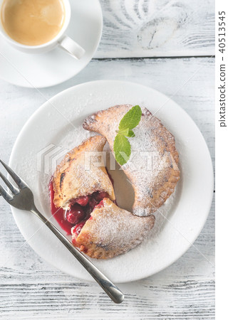 Cherry empanadas with cup of coffee 40513545