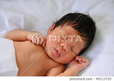 Newborn Concept. Newborn babies are sleeping in a bed. The baby 40513720