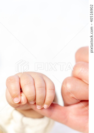 Baby grabs Baaba's little finger Close up 40516902