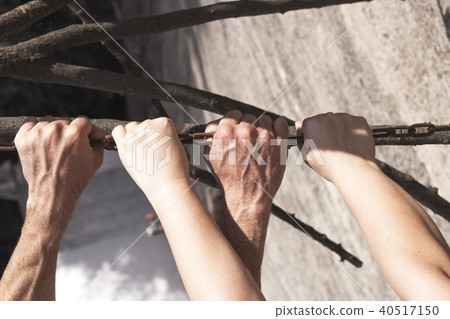 Hands holding and pulling a stick Hands holding and pulling a stick 40517150