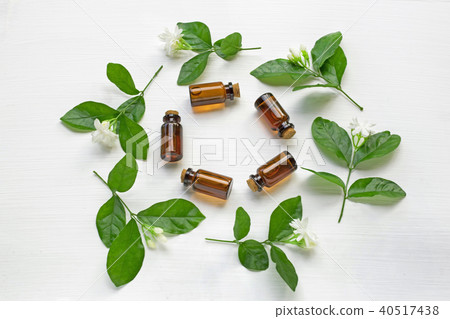 Dark brown Bottles of essential oil with jasmine. Dark brown Bottles of essential oil with jasmine. 40517438