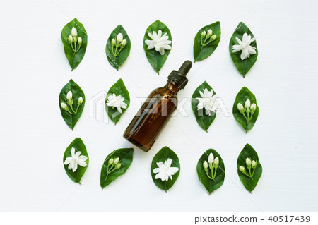 Dark brown Bottles of essential oil with jasmine. 40517439