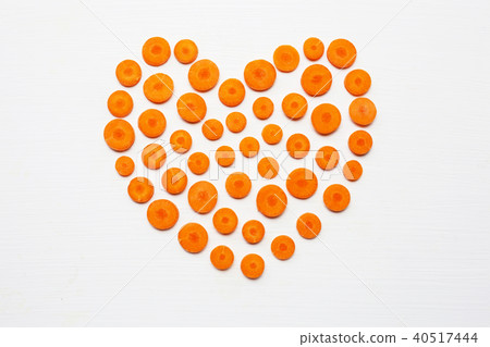 Chopped carrot slices heart shape isolated . Chopped carrot slices heart shape isolated . 40517444