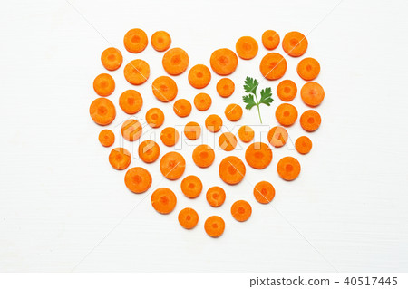 Chopped carrot slices heart shape and parsley. 40517445