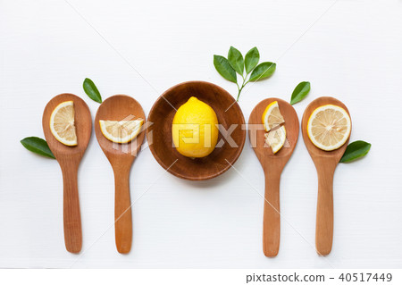 Lemon on wooden bowl and lemon slices. Lemon on wooden bowl and lemon slices. 40517449