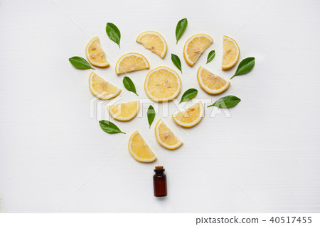 Lemon essential oil with fresh lemon and leaf. Lemon essential oil with fresh lemon and leaf. 40517455