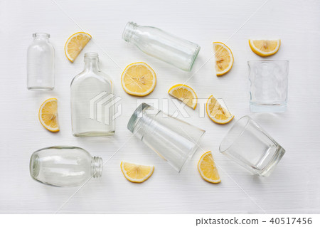 Glasses and bottle for drinks with lemon. Glasses and bottle for drinks with lemon. 40517456