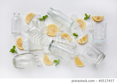 Glasses and bottle for drinks with lemon. Glasses and bottle for drinks with lemon. 40517457